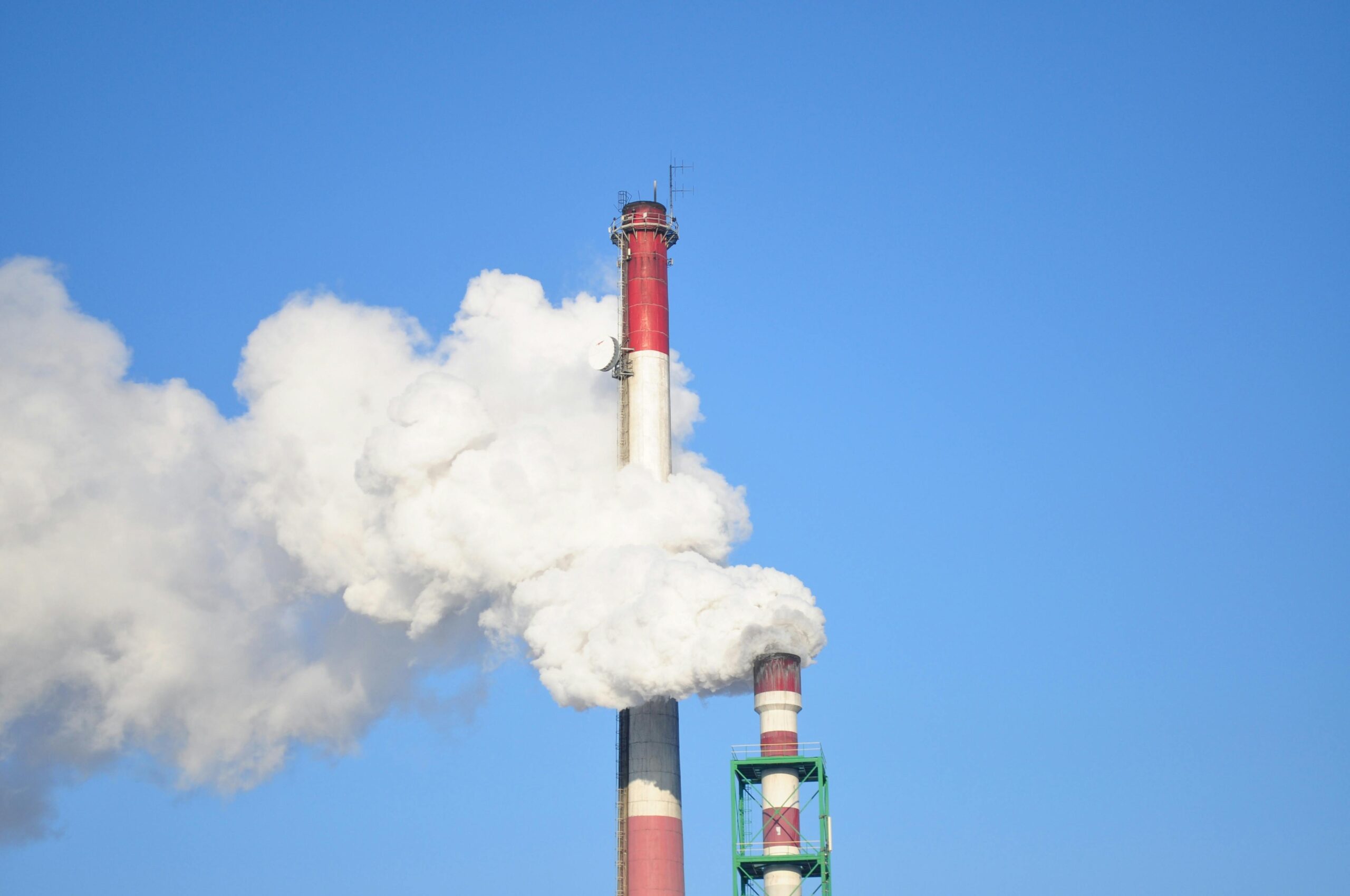 A photo of factory smoke stacks billowing clouds
