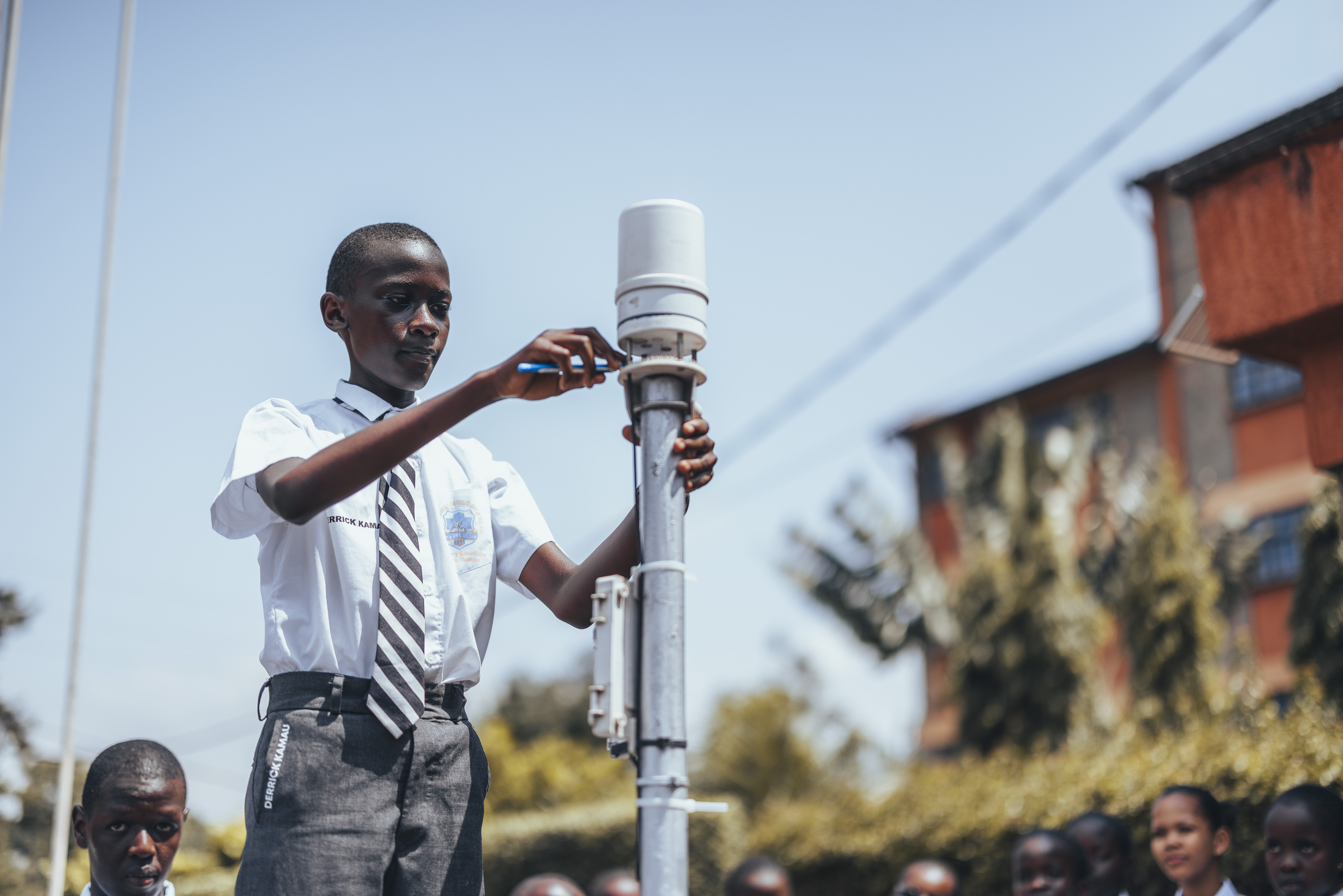 A student in Kenya installing an ATMOS 41 all-in-one weather station at their school in Kenya, who participates in the TAHMO project.